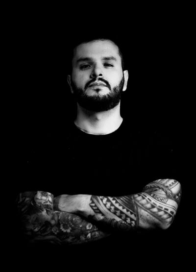 DJ's hands mixing electronic music on a controller